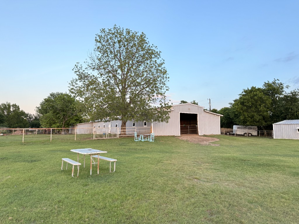Barn and shade tree with picnic table in the pasture