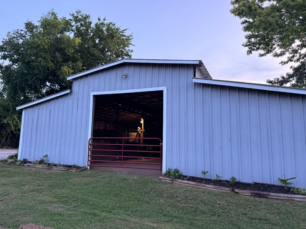 Front of the main barn with landscaped garden beds