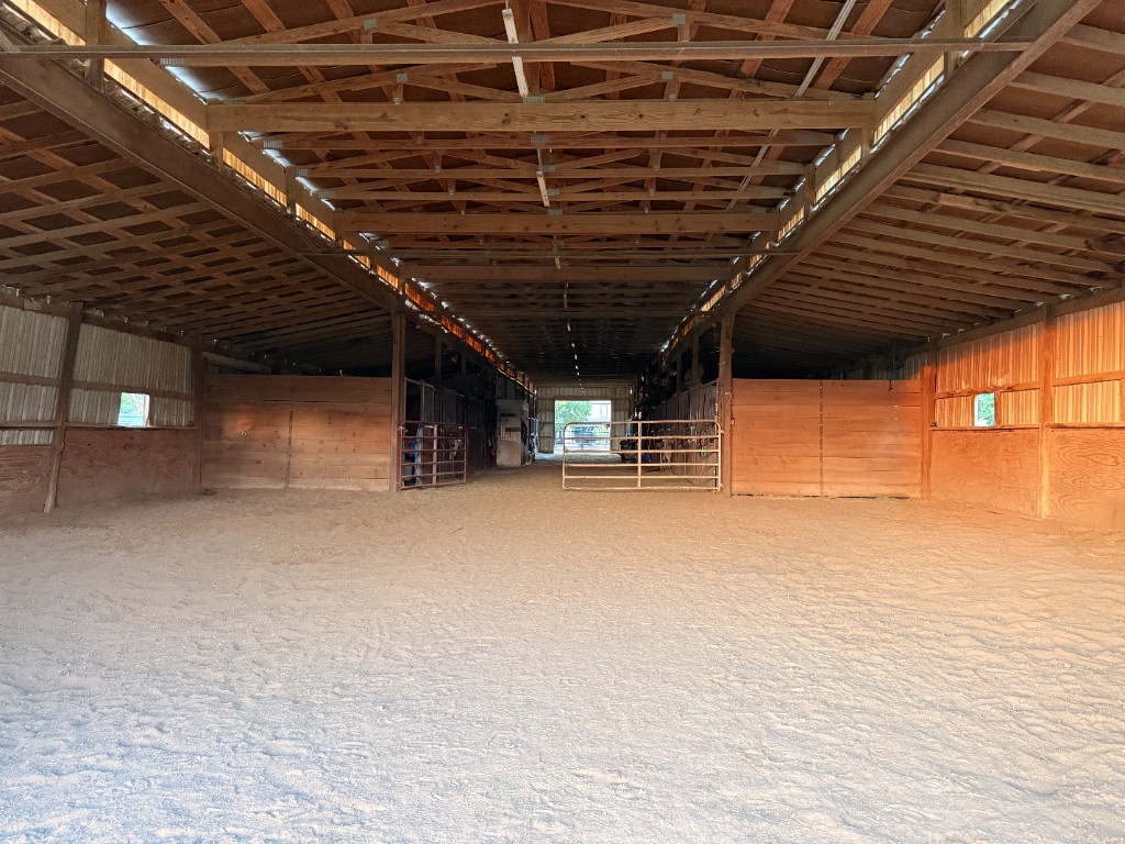 Indoor riding arena with warm evening light